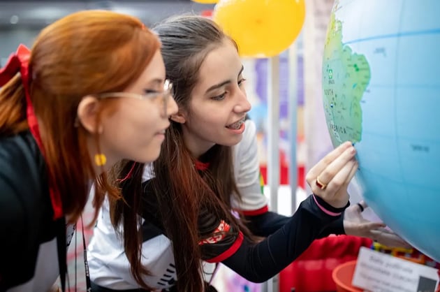 Students look at a globe