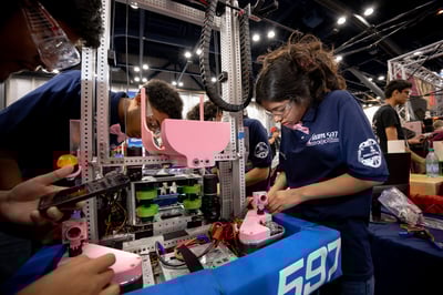 FIRST Robotics Competition students working on their team robot